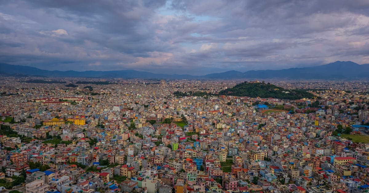 Vibrant aerial view of Kathmandu's cityscape showcasing colorful buildings under dramatic skies.