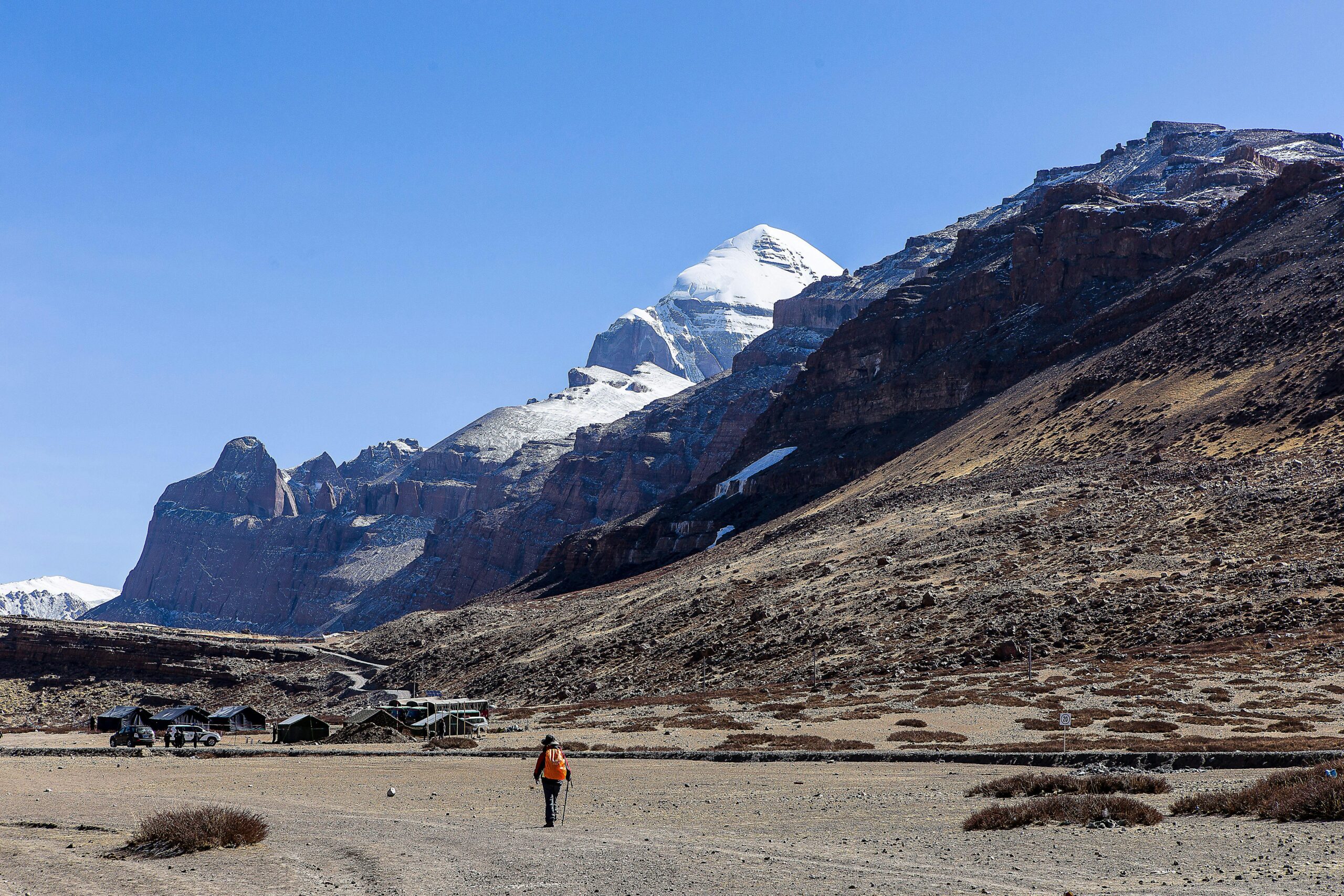 A traveller walks towards the majestic Mount Kailash in the Ngari region of Tibet, China.
