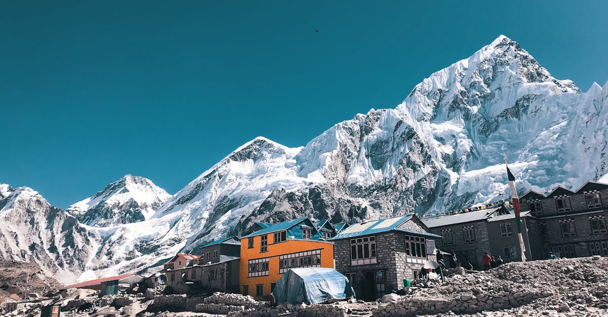 Vibrant houses beneath the majestic snow-capped peaks of the Himalayas in Khumjung, Nepal.
